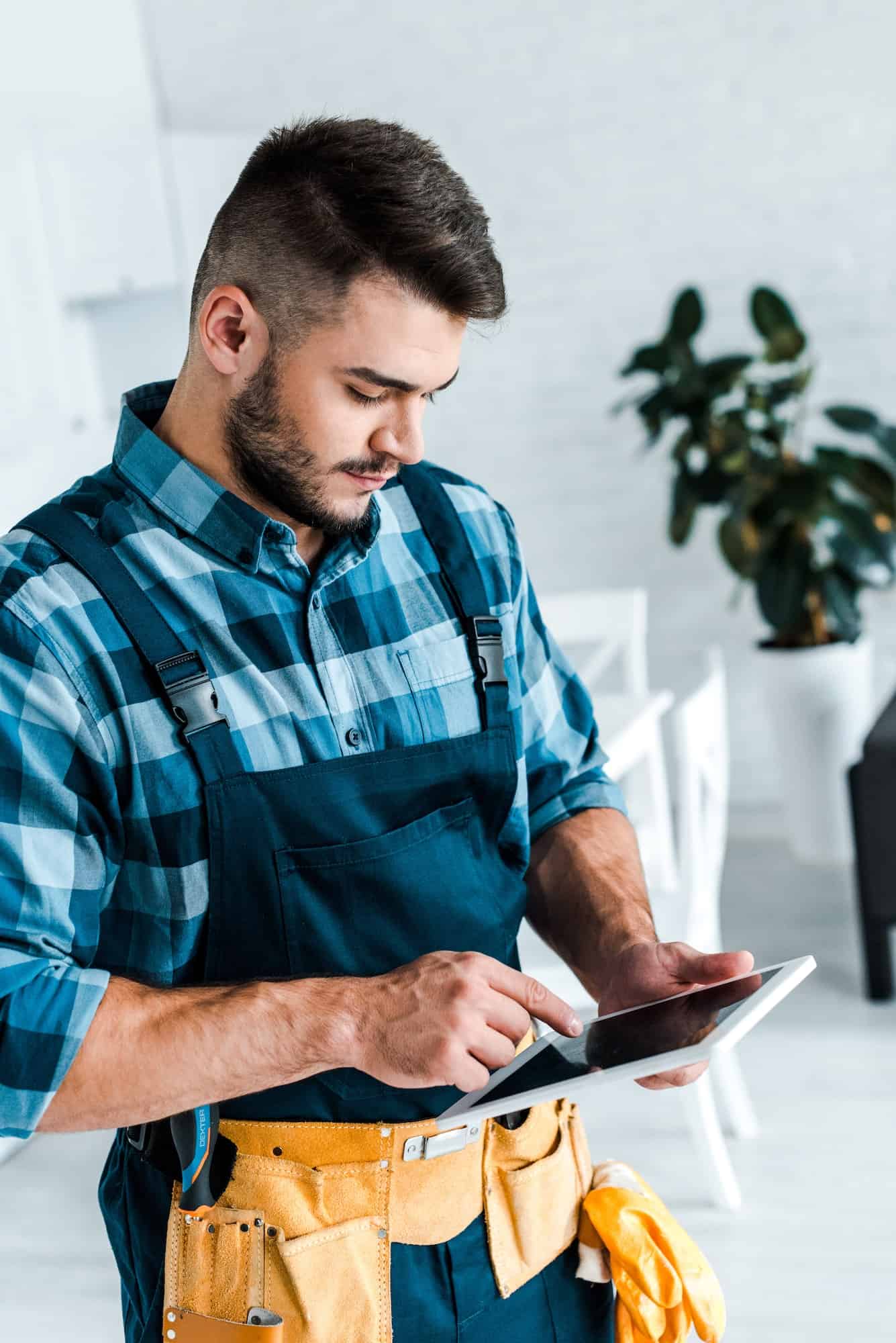 bearded-handyman-pointing-with-finger-at-digital-tablet.jpg bearded-handyman-pointing-with-finger-at-digital-tablet.jpg
