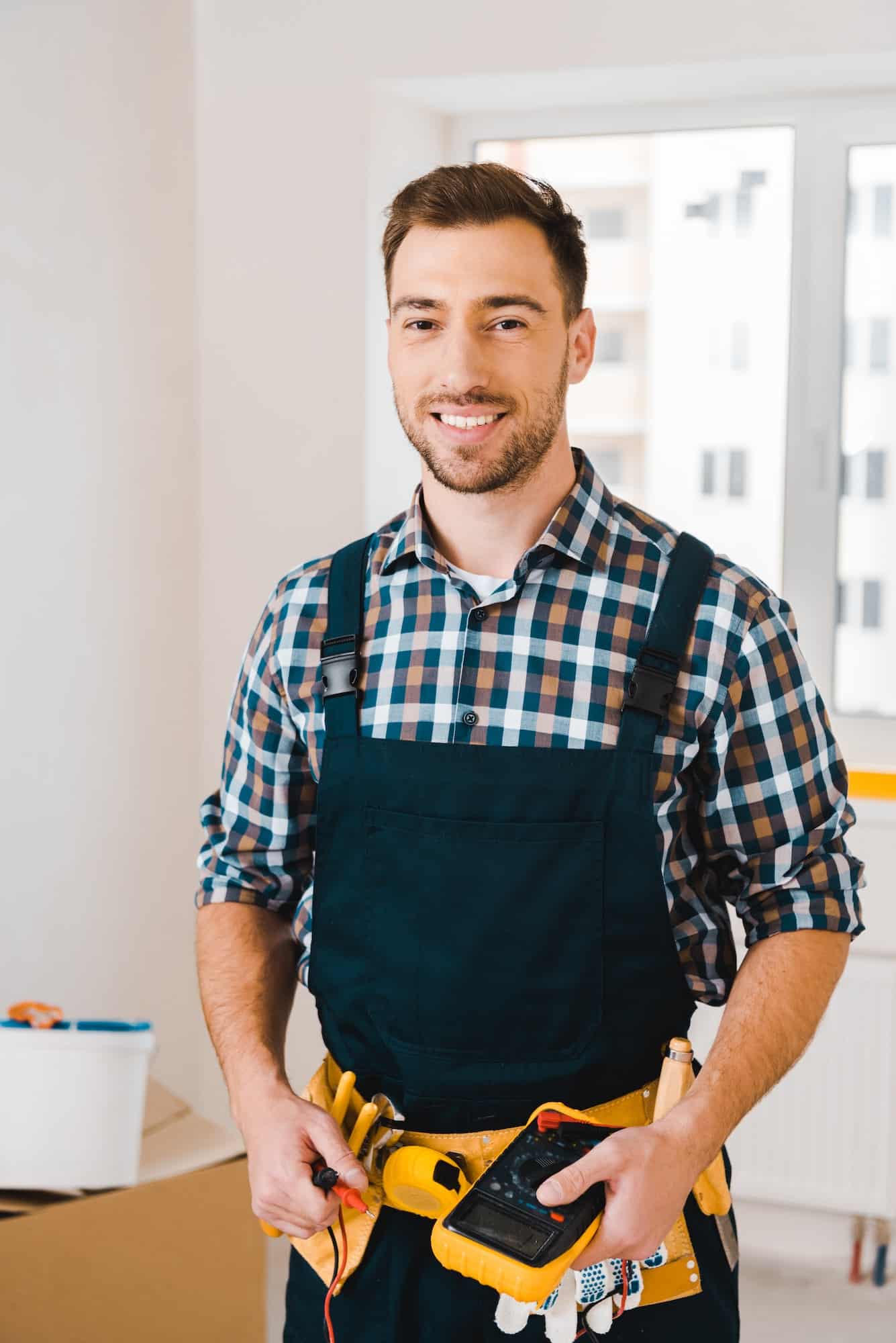 handsome-handyman-smiling-while-holding-digital-multimeter.jpg handsome-handyman-smiling-while-holding-digital-multimeter.jpg